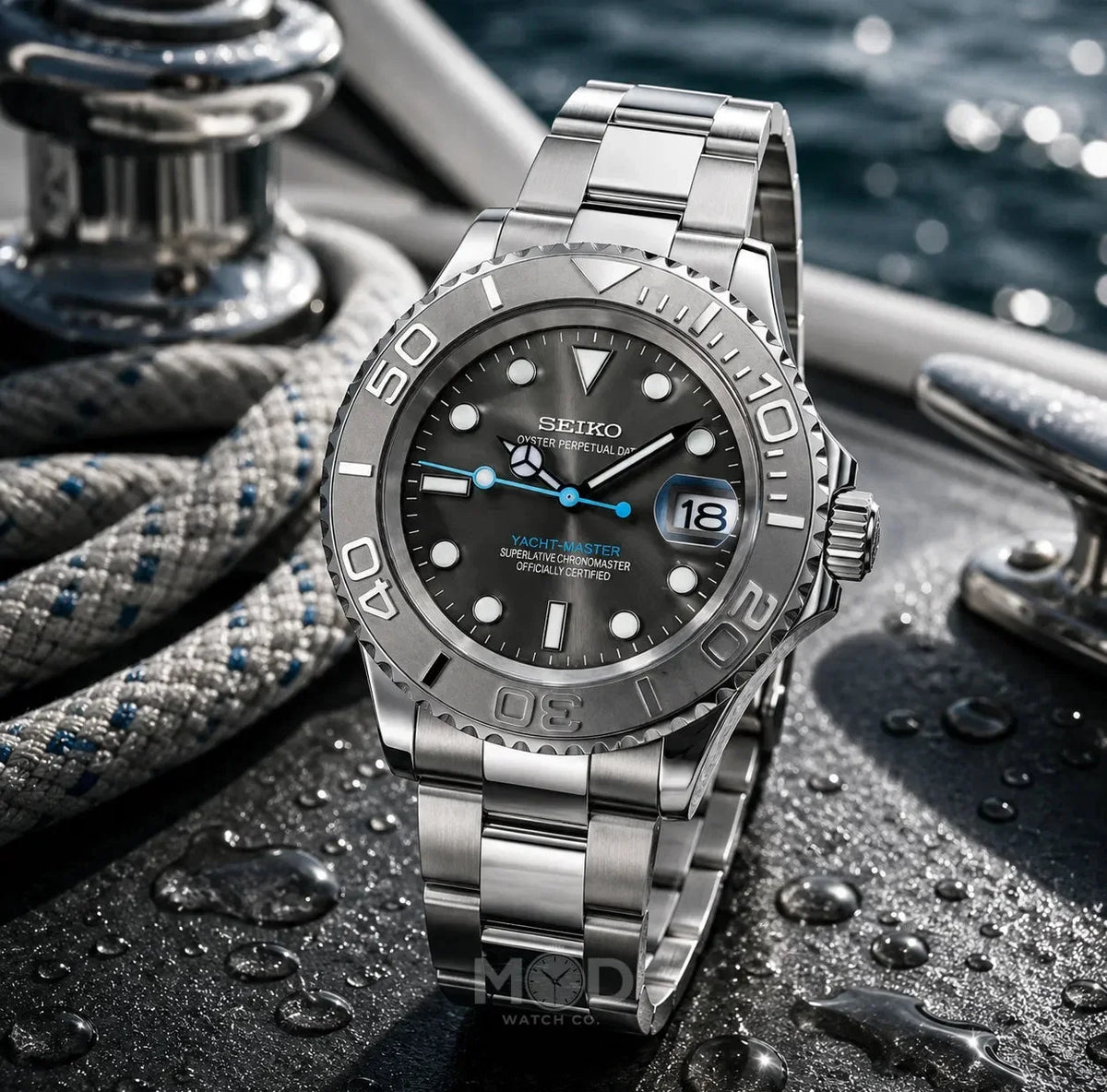 Silver Seiko watch on a textured surface with water droplets, yachts in the background