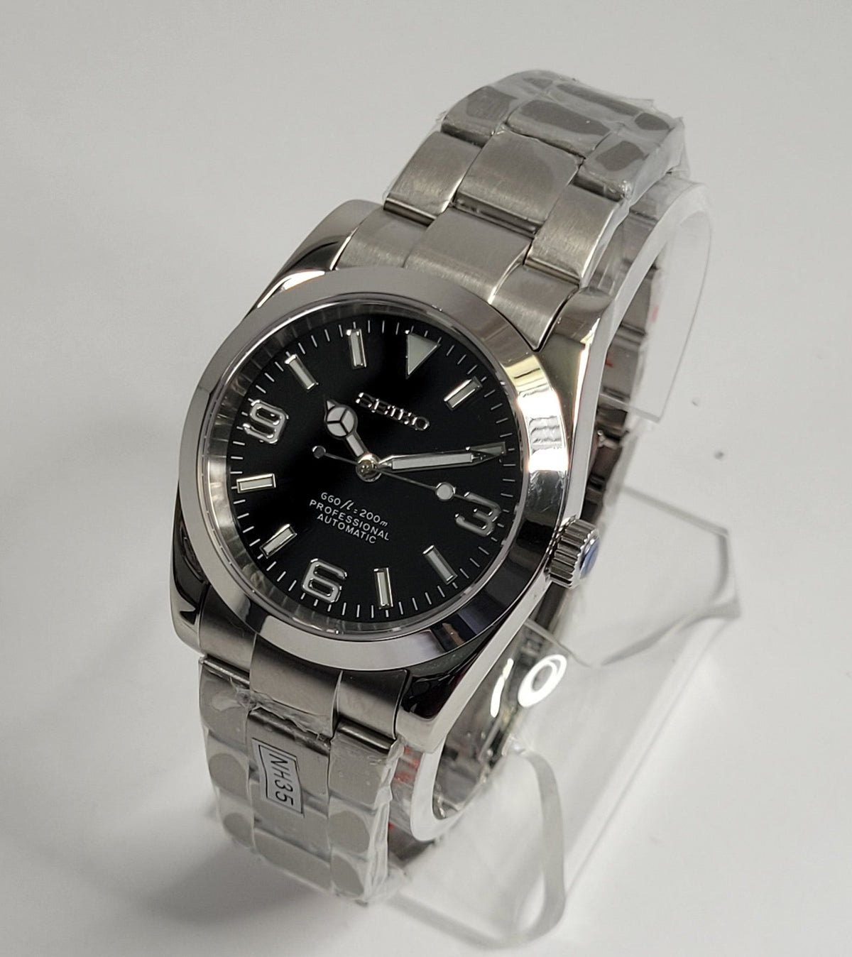 Silver watch with black dial on a gray background