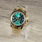 Gold Seiko watch with green face on a wooden surface