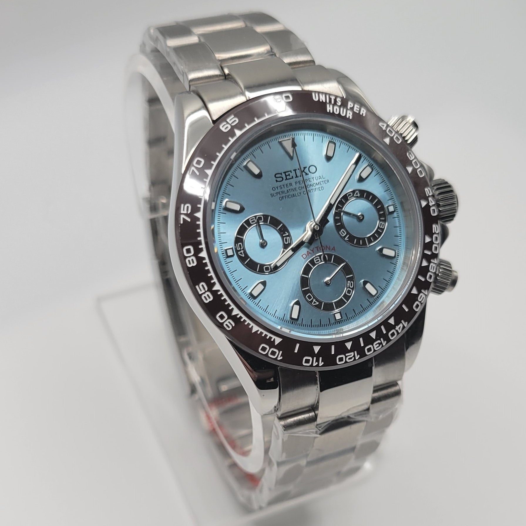 Silver Seiko watch with a blue face on a light gray background