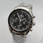 Silver Seiko watch with black dial on a white background