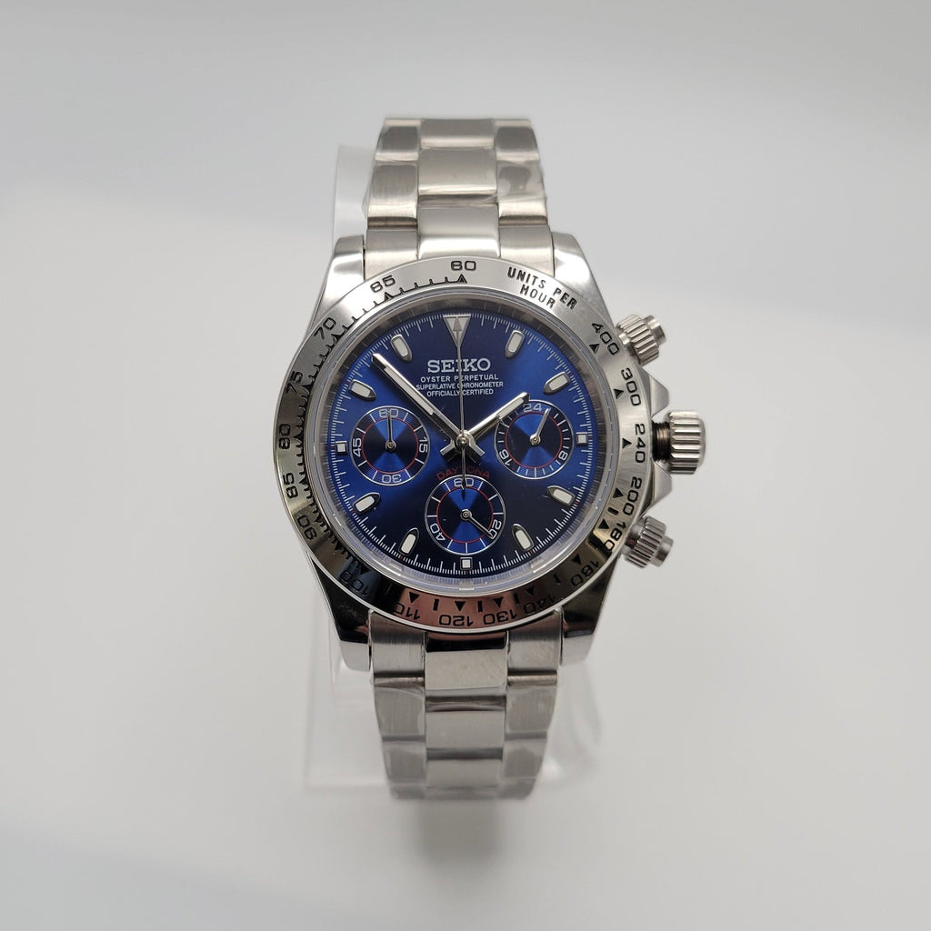 Silver Seiko watch with a blue face on a light gray background