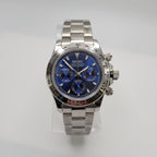 Silver Seiko watch with a blue face on a light gray background