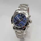 Silver Seiko watch with a blue face on a gray background