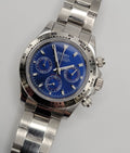 Silver Seiko watch with a blue face on a light gray background