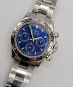 Silver Seiko watch with a blue face on a light gray background