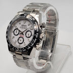 Silver Seiko watch on a clear stand against a white background