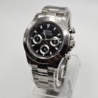 Seiko watch with black face and silver case on a white background