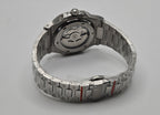 Silver watch with a detailed mechanism on a gray background