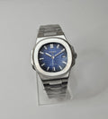 A custom Seiko Nautilus watch with a blue dial, stainless steel integrated bracelet, and a transparent case back displayed on a stand.