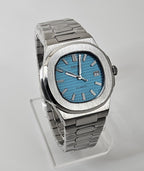 Silver watch with a blue face on a gray background