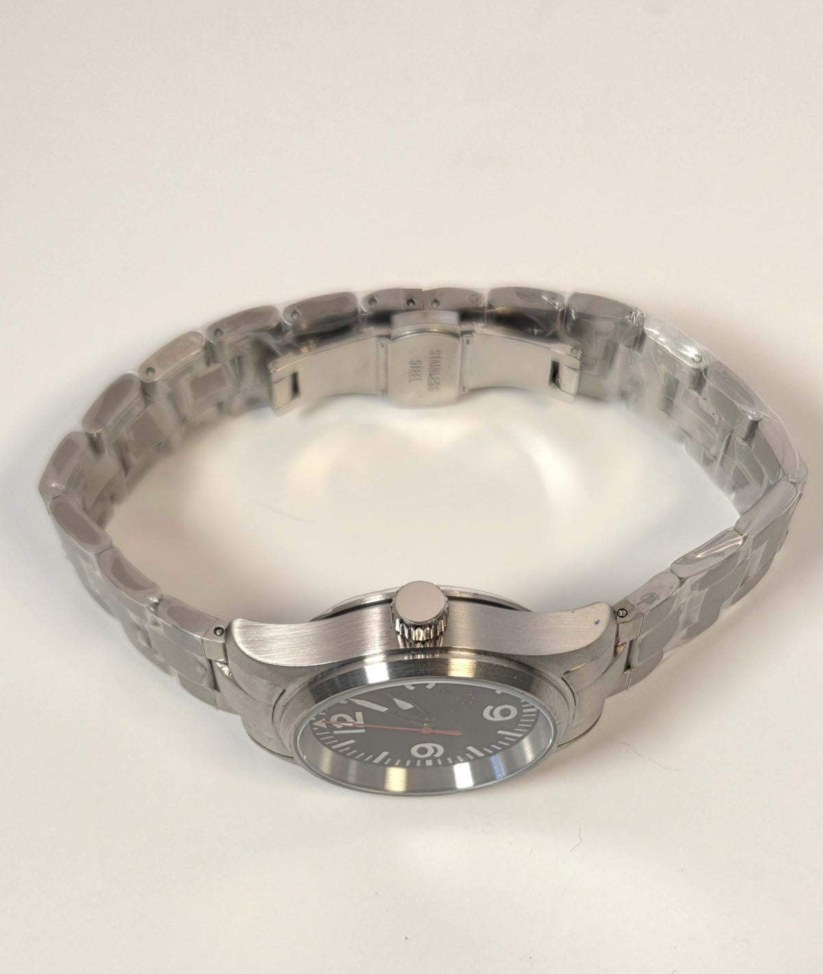 Silver watch on a light beige background