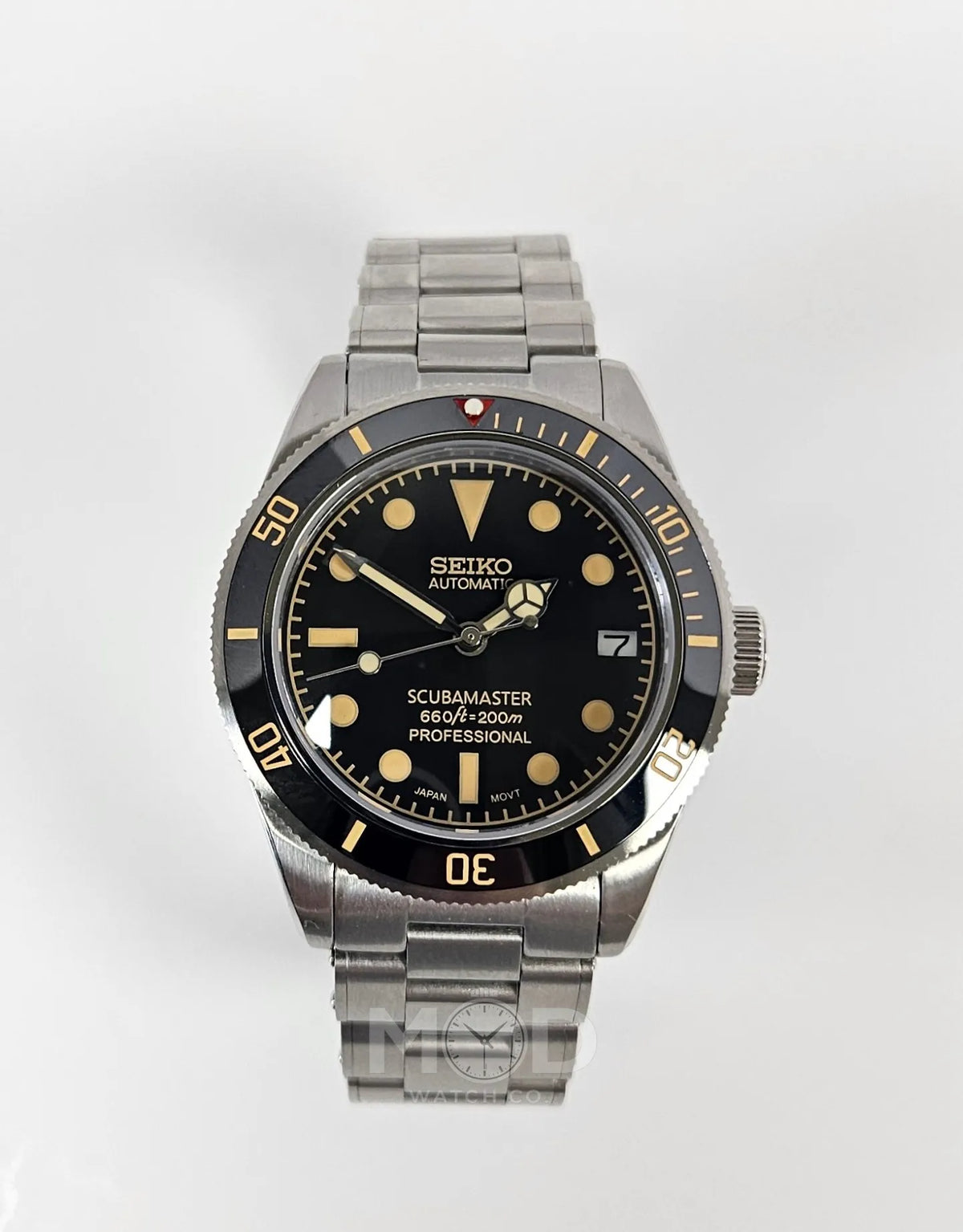 Seiko watch with black dial and silver metal strap on a white background