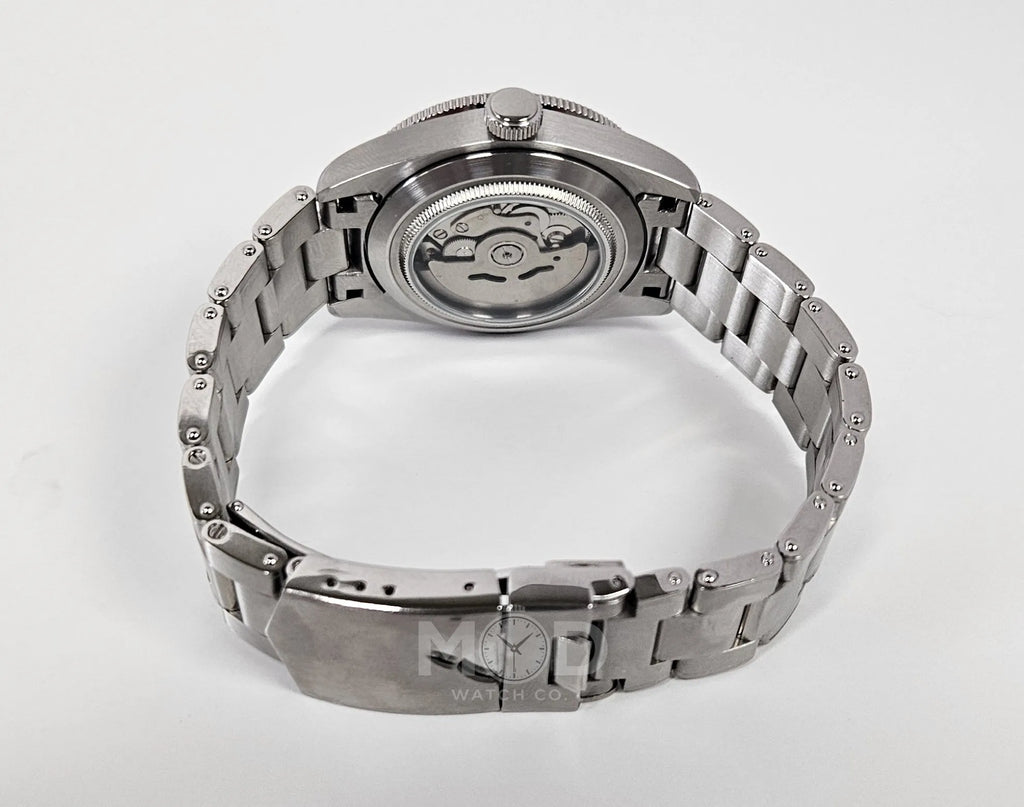 Silver watch with a detailed mechanism on a white background