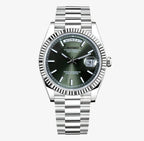 Silver Seiko mod watch with a olive green face on a white background