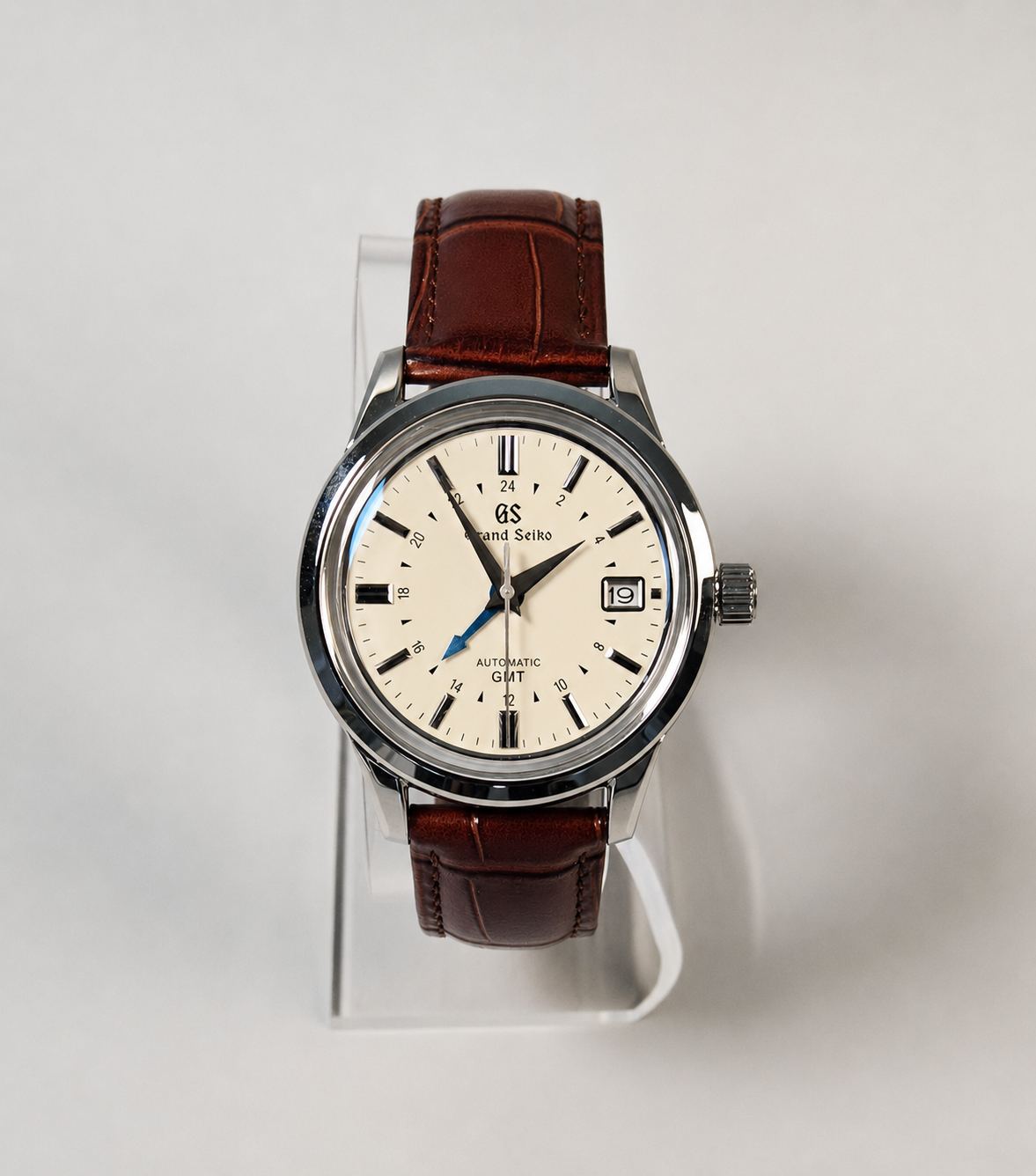 Wristwatch with brown leather strap on a white background