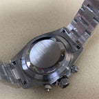 Close-up of a silver watch with a detailed metal band on a beige background