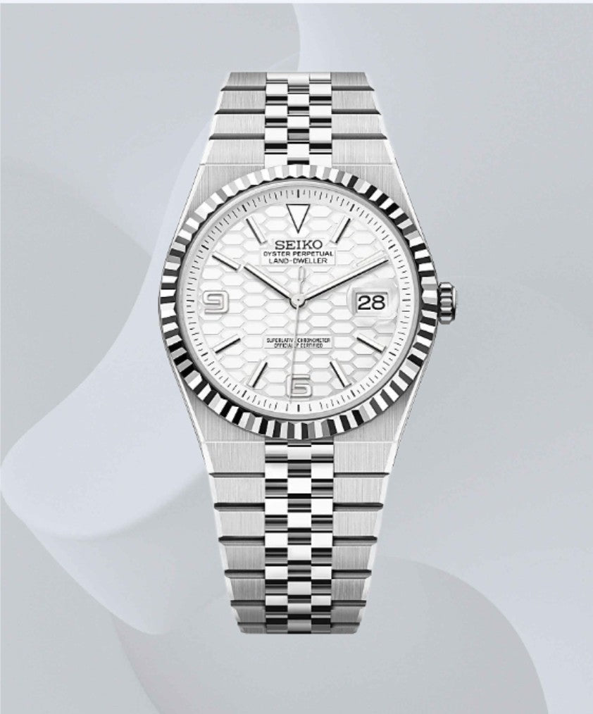 A Seiko stainless steel wristwatch with a fluted bezel, white textured dial, and matching steel link bracelet, shown against a light gray background with soft abstract wave shapes.