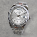 A Seiko Day-Specific wristwatch with a silver-tone stainless steel fluted bezel, silver dial, and matching steel link bracelet, shown on a light gray textured background.