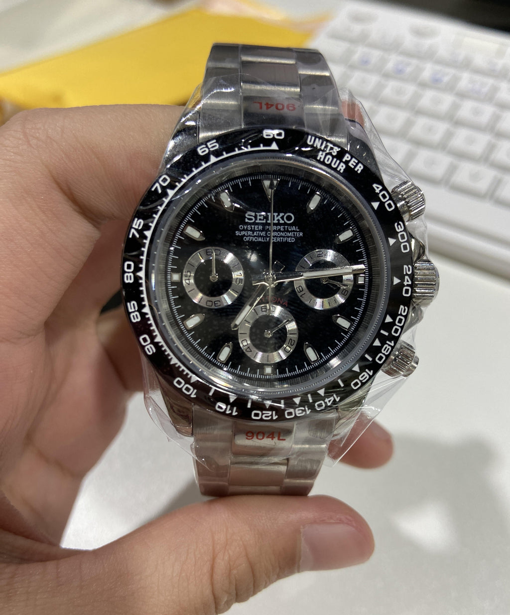 Seiko watch held in a hand with a blurred background