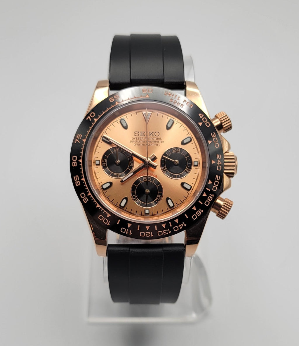 Seiko watch with black and rose gold design on a gray background
