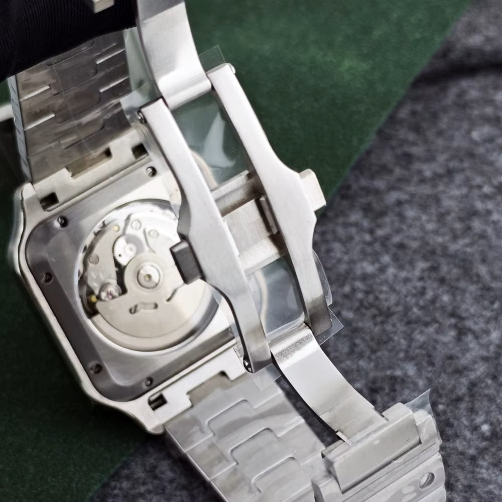 Close-up of a silver watch with a visible mechanical movement on a textured surface.