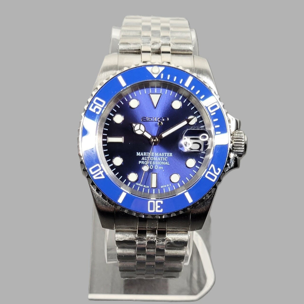Wristwatch with blue dial and silver metal band on a gray background