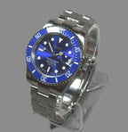Silver watch with blue dial on a gray background