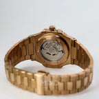 Rose Gold watch with mechanical components on a white background