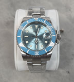 Silver Seiko watch with blue bezel and face on a gray background