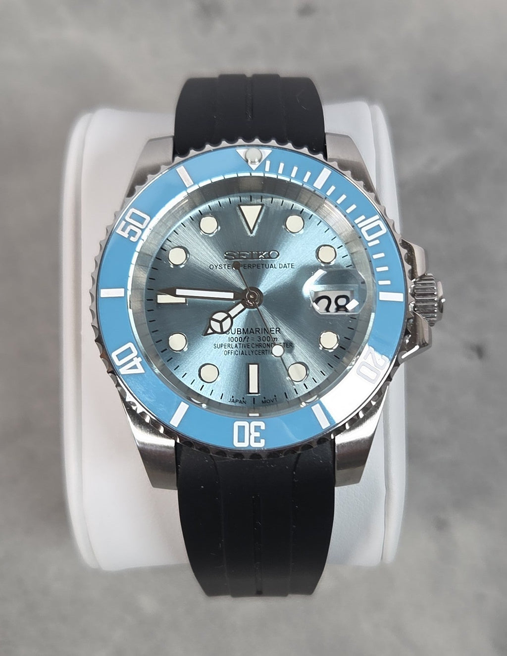 Watch with a blue dial and black strap on a gray background