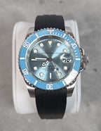 Watch with a blue dial and black strap on a gray background