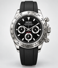 A Seiko Daytona wristwatch with a black dial, silver-tone stainless steel case, and a black rubber strap, shown against a light gray background.