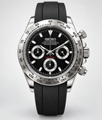 A Seiko Daytona wristwatch with a black dial, silver-tone stainless steel case, and a black rubber strap, shown against a light gray background.